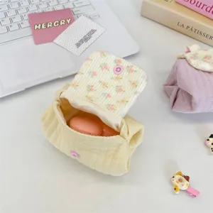 Detailed view of the floral lining inside the cream quilted small storage pouch