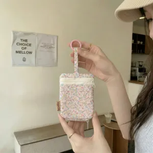 Floral pattern key pouch with dual zipper and hanging buckle for daily accessories and earphones.