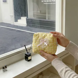 Yellow gingham quilted cosmetic bag with lace heart and cute pink bow for daily makeup storage.