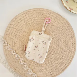Floral key pouch detail, canvas portable coin and earphone storage bag with double zipper.