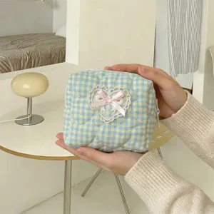 Cute quilted makeup pouch featuring a sweet lace heart and pink bow for daily use.