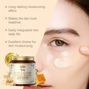 Closeup of beef tallow honey balm being applied on face, showing moisturizing texture details.