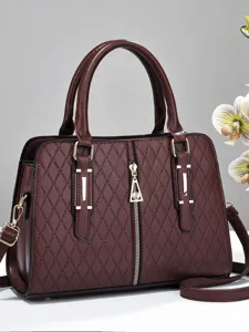 Wine red quilted structured handbag with diamond embossing and gold-tone hardware details.