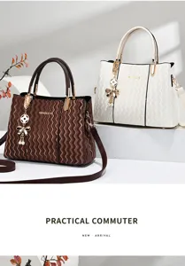 Detail view of stylish wave pattern shoulder bag with elegant pendant and spacious design.