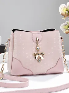 Elegant pink women shoulder bucket bag with chic bow pendant and gold chain straps style.