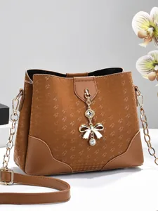 Trendy women's shoulder bag with stylish printed pattern and elegant bow pendant for daily use.