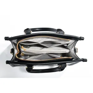 Detailed top view of black leather tote bag interior showing multi-compartment lining structure.