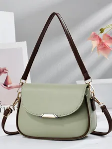 Elegant light green saddle shoulder bag with contrast brown trim for women daily commuting.