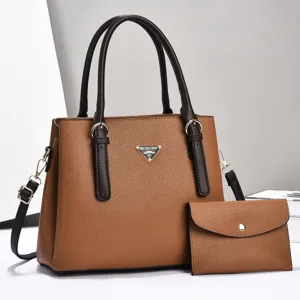 Fashionable brown PU leather shoulder handbag with matching small pouch, large capacity.