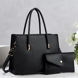 Detail view of black leather tote bag with matching pouch, premium texture, chic commuter style.
