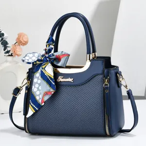 Stylish women's dark blue shoulder tote bag with silk scarf accessory and metal details.