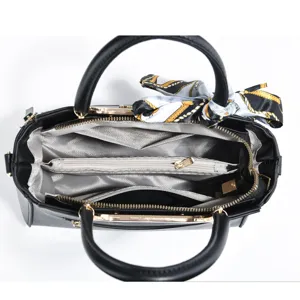 Black tote handbag interior detail showing large capacity, multiple compartments and silk scarf.