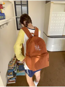 Japanese Harajuku style plaid school backpack with letter embroidery, large capacity campus bag.