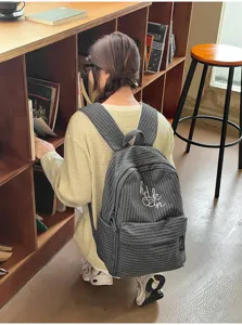 Detailed view of Japanese Harajuku style plaid student backpack with front embroidery.