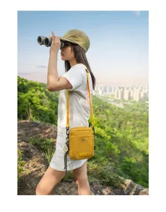 Outdoor casual crossbody bag detail, stylish yellow small shoulder bag for travel commuting.