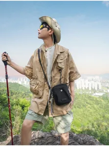 Black nylon outdoor crossbody bag for men, stylish casual shoulder sling bag for daily travel.