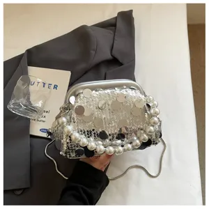 Stylish silver sequin kiss-lock shoulder bag with large pearl handle for evening party.