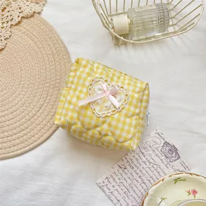 Yellow checkered quilted cosmetic bag with cute lace heart and pink bow for daily use.