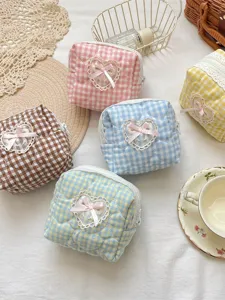 Cute quilted cosmetic bag with plaid pattern, lace heart, and bow, perfect for daily storage.
