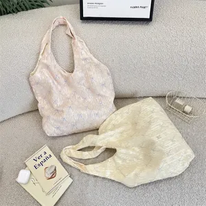 Detail shot of casual bow-textured shoulder bag in soft aesthetic lifestyle scene setting.
