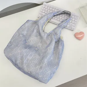Chic blue sheer shoulder bag featuring cute pink bow print, perfect aesthetic daily tote bag.
