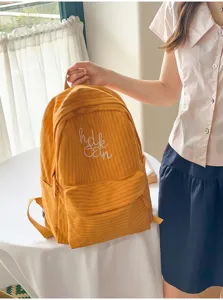 Japanese style plaid large capacity student backpack with cute letter embroidery design.