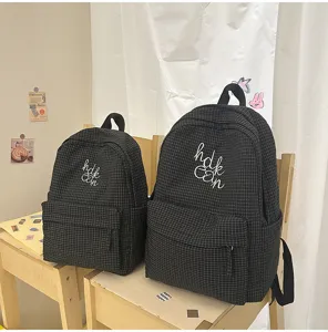 Japanese ins style plaid large capacity student backpack with cute letter embroidery.