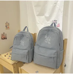 Detailed view of Japanese Harajuku style plaid school backpack with cute letter embroidery.