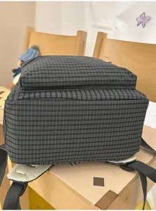 Japanese style grid large capacity student school backpack for teenagers and women casual daily use.