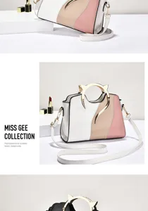 Detail view of stylish colorblock handbag with metal cat ear handle and shoulder strap.