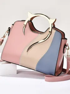 Stylish color-block women's shoulder bag with unique gold cat ear handle for daily commute.