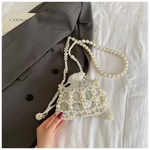 Detailansicht einer stilvollen weißen Perlen Eimer Tasche mit Satinfutter und Kette.