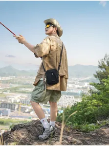 Compact black crossbody bag for men, ideal outdoor travel shoulder bag for hiking.