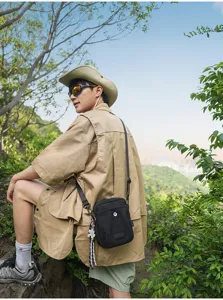 Unisex black canvas crossbody bag with plaid pendant, perfect for outdoor travel daily use.