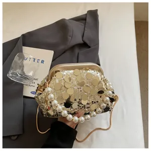 Exquisite sequined evening clutch bag with elegant pearl handle, stylish crossbody detail.