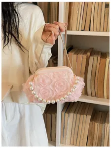 Chic pink floral kiss-lock shoulder bag with pearl strap and gold chain detail for women.