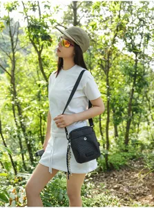 Outdoor casual plaid cross-body bag detail shot in nature forest setting, stylish and compact.