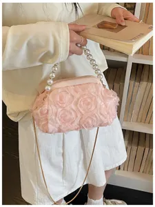 Pink rose pearl handle evening bag detail shot, elegant shoulder crossbody bag for women.