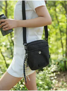 Casual grid crossbody bag for outdoor hiking and travel, compact and stylish unisex design.