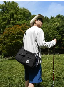 Black nylon messenger bag for daily commuting, casual crossbody shoulder bag for students.