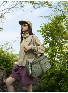 Fashionable nylon messenger bag detail shot showing convenient multi-pocket design style.