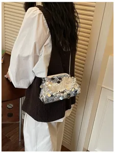 Detailed view of the sparkling sequin pearl kiss-lock evening shoulder bag worn by model.