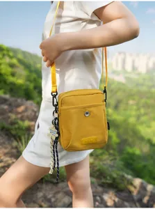 Casual yellow crossbody bag for outdoor travel, stylish small shoulder bag design.