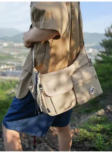 Casual nylon messenger bag for students, multi-pocket crossbody bag with cool charms.