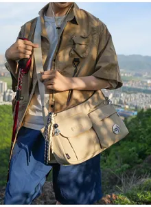 Casual nylon crossbody messenger bag detail with multiple front pockets and outdoor strap.