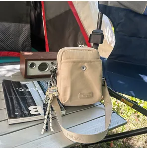 Beige outdoor crossbody bag stylish casual small shoulder bag for travel commute hiking.