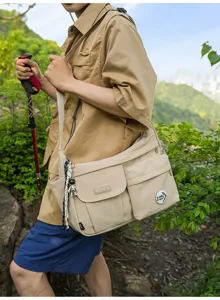 Outdoor casual nylon messenger bag detail shot showing multi-pocket design and strap.