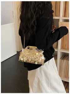 Detail shot of sparkling sequin pearl kiss lock evening shoulder bag in lifestyle setting.