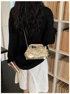 Detail view of a glamorous sequined kiss-lock evening shoulder bag with chain strap.