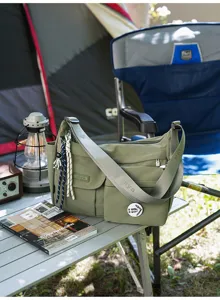 Detailed view of casual nylon messenger bag with multiple pockets, outdoor style crossbody.